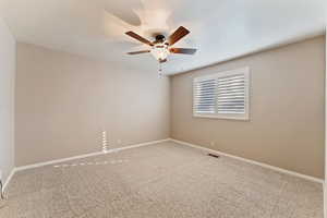 Spare room featuring ceiling fan and carpet floors