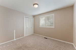 Unfurnished bedroom with carpet flooring and a closet