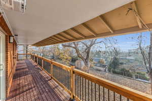 Wooden terrace featuring a storage shed