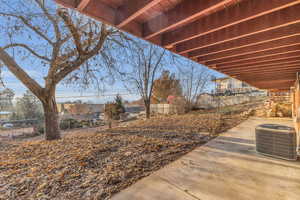 View of yard featuring a patio and central AC unit