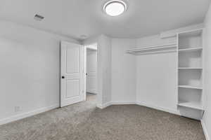 Unfurnished bedroom with carpet flooring, a textured ceiling, and a closet