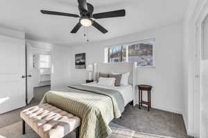 Carpeted bedroom featuring ceiling fan