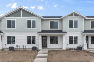 View of front of home featuring central AC