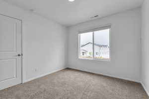 View of carpeted spare room