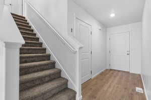 Foyer with wood-type flooring