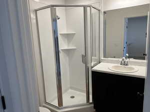 Bathroom with vanity and a shower with shower door