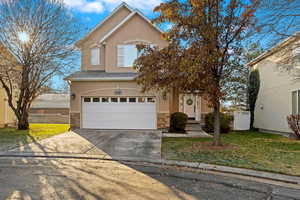 View of front property with a front lawn and a garage