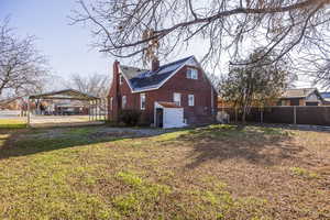 Rear view of house with a yard and a carport