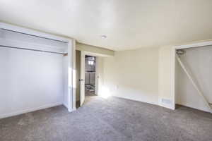 Unfurnished bedroom with carpet floors, washer / clothes dryer, and a closet