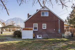 Rear view of house featuring a mountain view and a carport