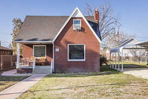 View of front of house featuring covered porch and a front yard