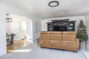 Living room featuring light hardwood / wood-style floors and a textured ceiling