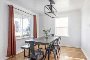 Dining room featuring a chandelier and light wood-type flooring