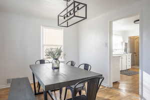 Dining room featuring light wood-type flooring and a wealth of natural light