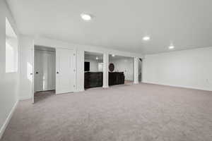 Basement with light colored carpet