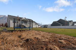 View of yard featuring a mountain view and a trampoline