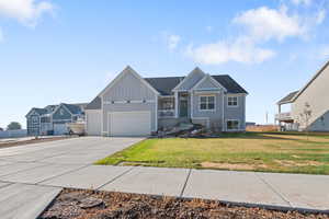 View of front of home featuring a front yard and a garage