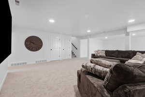 Living room featuring light colored carpet