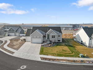 View of front of house with a front yard and a garage