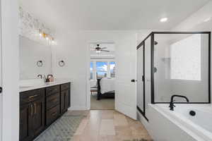 Bathroom featuring ceiling fan, tile patterned flooring, vanity, and plus walk in shower