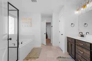 Primary bathroom with walk-in shower and separate tub.