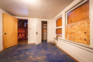 Empty room featuring a textured ceiling