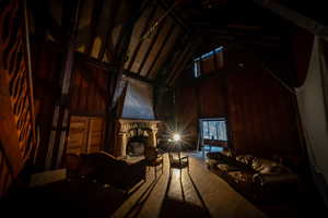 Interior space featuring wood walls and high vaulted ceiling