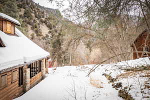 Snowy yard featuring a mountain view