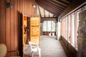 Interior space featuring wood walls and vaulted ceiling