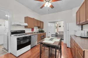 Kitchen featuring white appliances, light hardwood / wood-style flooring, and extractor fan