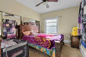 Carpeted bedroom featuring ceiling fan