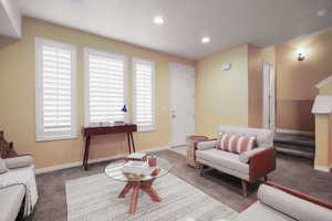 Carpeted living room featuring a healthy amount of sunlight