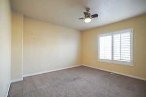 Unfurnished room with carpet and ceiling fan