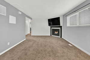 Unfurnished living room featuring carpet floors