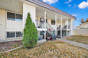 Doorway to property featuring covered porch