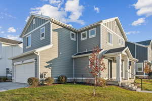 View of front of house featuring a front yard and a garage