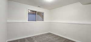 Carpeted empty room with a textured ceiling