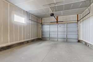 Garage featuring a garage door opener