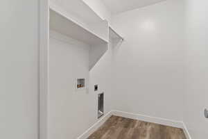 Laundry room with hookup for an electric dryer, hookup for a washing machine, and hardwood / wood-style floors