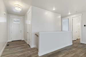 Entrance foyer with hardwood / wood-style flooring