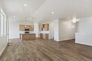 Interior space with hardwood / wood-style floors and lofted ceiling