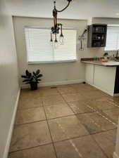 Unfurnished dining area with tile patterned floors