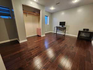 Bedroom 5 featuring a closet and dark wood-type flooring