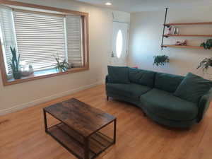 Living room with light hardwood / wood-style flooring