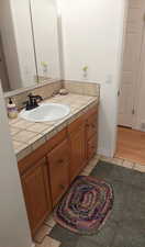 Bathroom with hardwood / wood-style floors and vanity