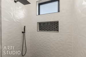 Bathroom featuring a tile shower