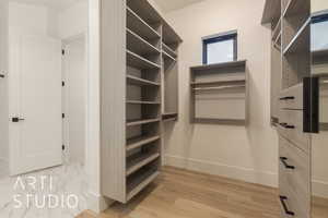 Walk in closet featuring light wood-type flooring