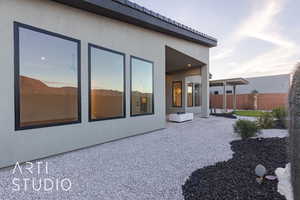 Back house at dusk with a patio