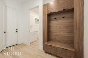 Mudroom with light hardwood / wood-style floors