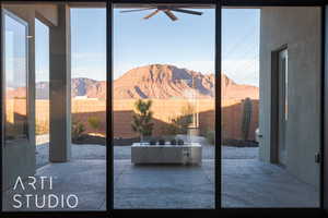 Entryway featuring a mountain view, carpet, and ceiling fan